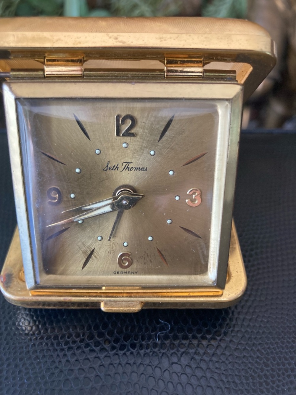 Classic mid-century Seth Thomas folding travel alarm clock in gold-tone texture